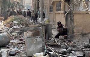 An opposition fighter fires as he holds a position with fellow comrades in the northeastern Syrian city of Deir Ezzor on Tuesday ( Wednesday in Manila). The war in Syria has devastated much of the country, particularly in areas that are now under rebel control. AFP PHOTO