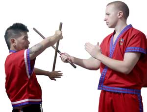 The attacker (right) delivers a strike using his cane while Punong Lakan Garitony Nicolas counters with a vertical block.