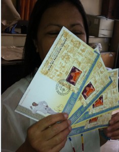 Perla Goco of the Philatelic division of the Philippine Postal Corp. shows a First Day Cover featuring Dolphy. The country’s King of Comedy, who died in July last year, is featured in a special issue to celebrate National Stamp Collection Month.  Photo By Leena Chu 