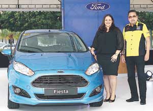 Ford Phlls. Managing Director Kay Hart (left) presents the new Ford Fiesta variant with Ray Butch Gamboa, the chief executive of STV, organizer of the Auto Focus Motor Show.