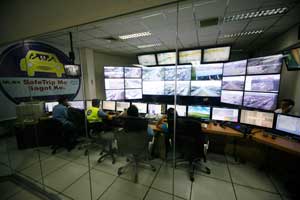 Employees of the North Luzon Expressway monitor the flow of vehicles in the NLEX via closed circuit television on Friday, when the exodus of Metro Manila residents reached one of its peak periods for the year. PHOTO BY MIGUEL DE GUZMAN