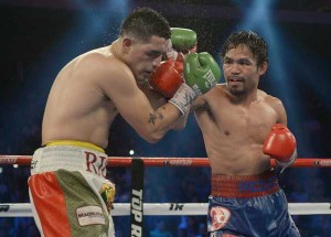 Manny Pacquiao (right) deals Brandon Rios a lesson in clinical boxing during their fight for the World Boxing Organization International welterweight title in Macau on Sunday. AFP PHOTO