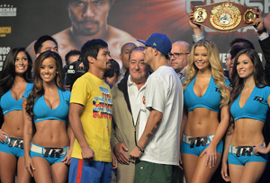 Manny Pacquiao (front center left) and Brandon Rios face-off after taking to the scale during the official weigh-in event in Macau on November 23, 2013, one day ahead of their welterweight bout. AFP PHOTO