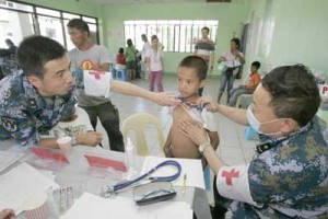 Chinese doctors from the floating hospital Peace Ark examine a boy during their mercy mission at the Leyte Provincial Hospital in Palo, Leyte. PHOTO BY RENE H. DILAN