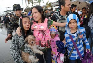 A mother and her children cry after failing to take a flight on a C-130 military plane out of Tacloban City on Tuesday. Hundreds of residents are desperate to leave the city, which is running low on food and water. AFP PHOTO