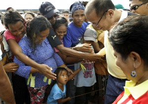 President Benigno Aquino 3rd greets a girl who waited for him in Zamboanga City. The President on Sunday inspected the bunkhouses for internally displaced persons at the city’s Joachin Enriquez Memorial Sports Complex. Malacañang photo 