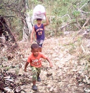 Aetas carrying relief goods. PHOTO BY GHIO ONG