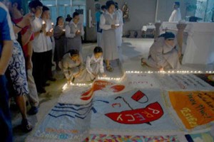 On World AIDS Day Sunday, candles are lighted around quilts made by victims of HIV-AIDS who died of complications in a church in Manila. AFP PHOTO