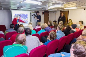 A photo taken by passenger Andrew Peacock of www.footloosefotography.com on Sunday shows passengers receiving a briefing about the latest ice conditions report from expedition co-leader Greg Mortimer (back left) on board the MV Akademik Shokalskiy as it waits to be rescued. AFP PHOTO