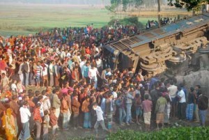 Bangladeshi onlookers gather at the scene of a derailed train in Gaibandha, some 200 kms north from Dhaka on Wednesday. Opposition activists derailed a train in Bangladesh, killing three people, as part of a campaign against elections due to be held next month, officials said. AFP PHOTO