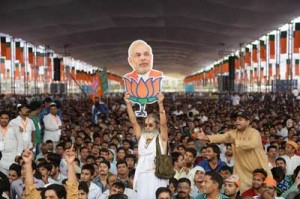 A file photo taken on September 29 shows a supporter of the Bharatiya Janata Party(BJP) holding a cutout of Gujarat state Chief Minister and the BJP prime ministerial candidate Narendra Modi during an election rally in New Delhi. AFP PHOTO