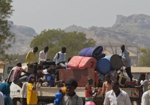 Residents of Juba with their belongings pile onto a truck heading out of the city on Saturday where tension remains high fueling an exodus of both local and foreign residents from the south Sudanese capital. AFP PHOTO