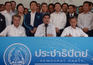 Democrat party leader Abhisit Vejjajiva (center) speaks next to his party members during a press conference at the Democrat party in Bangkok on Saturday. Thai opposition protesters are gearing up for fresh mass rally on Sunday. AFP PHOTO