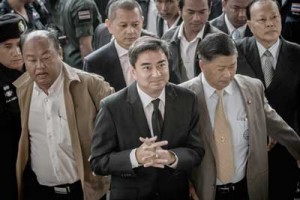 Former Thai Prime Minister Abhisit Vejjajiva (center) arrives at the court in Bangkok on Thursday. AFP PHOTO