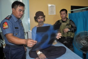 Jordanian TV journalist Baker Atyani studies the results of his x-ray at a hospital in Jolo, Sulu province. The newsman was captured by the Abu Sayyaf one and a half years ago. AFP PHOTO