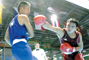 Wilfredo Lopez (left) of the Philippines fights Alex Tatontos of Indonesia (right) during their middleweight boxing match at the Wunna Theikdi Boxing Center during the 2013 SEA Games in Naypyidaw, Myanmar. But unlike this high-level tournament, trained referees, a proper boxing ring and  a stand-by sports physician are lacking in ‘underground’ boxing bouts posing serious risks  to the participants.  AFP PHOTO 