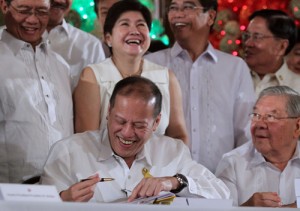 President Benigno Aquino 3rd and other government officials share a laugh after the signing of the 2014 budget at the Rizal Hall in Malacanang. MALACAÑANG PHOTO 