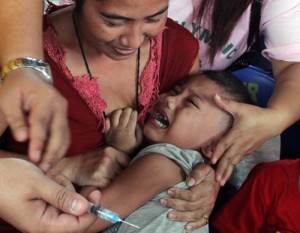   A child cries as a personnel of the Department of Health (DOH) prepares to give her a shot for measles in Mandaluyong City. The DOH launched a massive vaccination campaign to prevent a measles outbreak in Metro Manila. PHOTO BY MIKE DE JUAN 