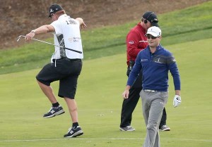 Zach Johnson smiles as caddie Damon Green celebrates after Johnson holed out from the drop zone after going in the water on the 18th hole to force a playoff during the final round of the Northwestern Mutual World Challenge at Sherwood Country Club in Thousand Oaks, California. AFP PHOTO