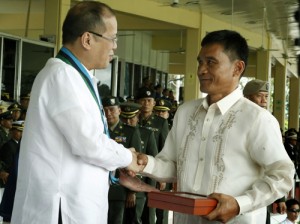 President Benigno S. Aquino III presents the Medal of Valor (Posthumous) to Private First Class Ian Paquit, represented by his father Eduardo Paquit, during the 78th Founding Anniversary of the Armed Forces of the Philippines (AFP) at the AFP General Headquarters Grandstand in Camp General Emilio Aguinaldo, Quezon City on Friday (December 20, 2013).  Photo by: Gil Nartea / Malacañang Photo Bureau