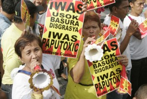  Health and environment advocates blow horns, which they said are safer than firecrackers, which in the past have injured dozens of New Year revelers.  Photo by Rene H. Dilan