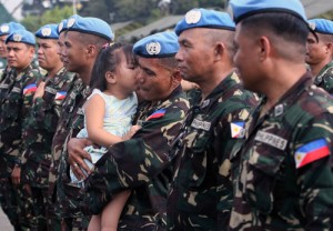 Filipino UN Peacekeeper Alejandro Vallecera gets a kiss from two-year-old granddaughter Ella. The peacekeepers returned home after a year of deployment and received a UN Service Medal during awarding ceremonies at Camp Aguinaldo, Quezon City on Wednesday. Photo By Mike De Juan 