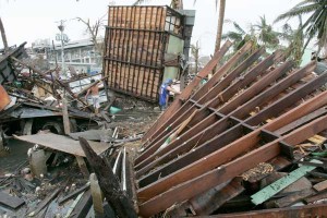 Residents scrounge for materials that they can reuse for temporary shelter until the government comes out with permanent relocation sites for Super Typhoon Yolanda survivors. PHOTO BY RENE H. DILAN