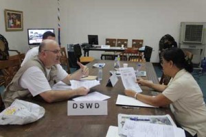 A DSWD social worker processes the donation of the International Medical Corps at the One-Stop- Station at Mactan Airbase