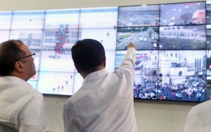 President Benigno Aquino 3rd watches images on a huge screen during the launch on Wednesday of the Traffic Signalization System and Command Control Center of the Metro Manila Development Authority.  Malacañang Photo 