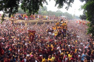 The image of the Black Nazarene, surrounded by throngs of devotees, approaches Jones Bridge. Photo By RUY MARTINEZ