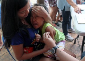 A child cries after getting a shot against measles during the vaccination campaign launched by the Pasig City health department on Thursday. Photo By Mike De Juan 