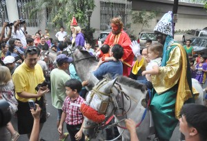 Men dressed as the Three Kings greet children in Manila on Sunday, the Feast of the Epiphany, which officially ends the Christmas season. The Philippines has the longest Christmas season in the world. PHOTO BY EDWIN MULI