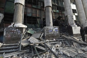 Egyptian policemen stand outside the court in the working class Imbaba neighborhood of Cairo on Tuesday after blast hit the building two hours before polls opened for Egyptians to vote on a new constitution. AFP PHOTO