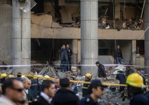 Egyptian emergency personnel inspect the site of a car bomb explosion outside the Cairo police headquarters on Friday, which killed at least four people in an early morning blast. AFP PHOTO