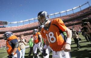 Peyton Manning No.18 of the Denver Broncos runs on to the field prior to the AFC Championship game against the New England Patriots at Sports Authority Field at Mile High in Denver, Colorado. AFP PHOTO