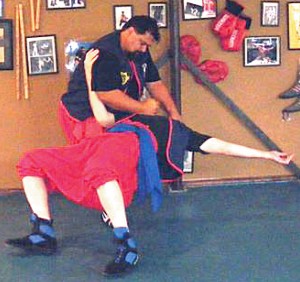 Buitron (standing) shows a rarely seen Savate takedown technique. PHOTOS COURTESY OF PROFESSEUR PAUL-RAYMOND BUITRON 