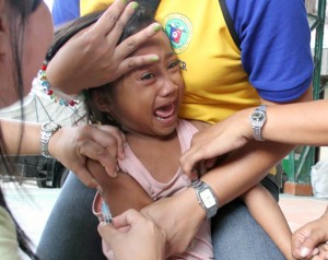 A young girl cries while being vaccinated for measles at a health center in Manila on Friday. The Department of Health is conducting a massive vaccination campaign throughout the National Capital Region following the recent deaths of two children plus an increase in the number of measles cases in five cities in the NCR. PHOTO BY MIKE DE JUAN