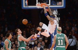 New York Knicks Kenyon Martin (second from right) smashes the ball against Boston Celtics players during an NBA game at Madison Square Garden in New York. AFP PHOTO