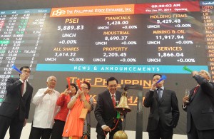 Officials of the Philippine Stock Exchange ring the bell and blow horns on Thursday to mark the first trading day of the year. AFP PHOTO