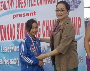 Former Senator Nikki Coseteng and gold medalist Portia Kate Doragos during the awarding ceremony of the Mindanao Swimming Championship. CONTRIBUTED PHOTO