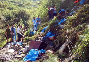 Police and rescuers sift through the wreckage of the bus at the bottom of a ravine in Bontoc, Mountain Province, on Friday morning. Two foreigners and a popular Filipino comedian were among those killed in the accident.  PHOTO BY THOM PICAÑA 