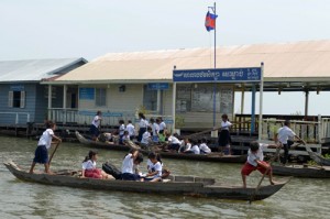 A file photo taken on October 14, 2013 shows Cambodian students rowing their boats as they leave a school at a floating village in Kampong Chhnang province, some 90 kilometers northeast of Phnom Penh. AFP PHOTO