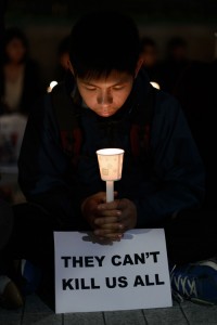 A protester holds a candle during a de–monstration in support of a former newspaper editor who was stabbed on Thursday. ‘ AFP PHOTO 