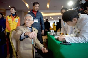 A man selected to attend the family reunions between North and South Koreans is checked by medical staff after arriving at the Hanwha resort in the eastern port city of Sockcho on Wednesday. AFP PHOTO