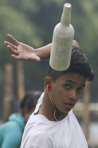 A student tosses a bottle as he practices bartending at the Quezon Memorial Circle in Quezon City on Sunday. The Department of Labor said 1.42 million young people are unemployed. PHOTO BY MIGUEL DE GUZMAN