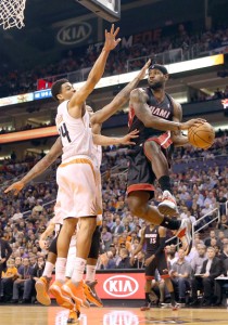 LeBron James No.6 of the Miami Heat makes a leaping pass past Gerald Green No.14 of the Phoenix Suns during the first half of the NBA game at US Airways Center on in Phoenix, Arizona. AFP PHOTO