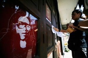 Fans offer flowers and candles at the store of comedian Arvin 