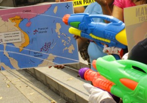 Members of militant groups fire water pistols at a map of the West Philippine Sea in a protest rally in front of the Chinese Consular Office in Makati City as a way of denouncing the water cannon attacks by China’s Coast Guard on Filipino fishermen at the Panatag Shoal. Photo By Ruy L. Martine 