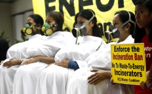 At a press conference on Friday, members of the environment watchdog EcoWaste Coalition dress up as pregnant women to dramatize the group’s protest against incineration plants and the open burning of trash which it claims is harmful especially to expectant mothers. Photo By Miguel De Guzman 