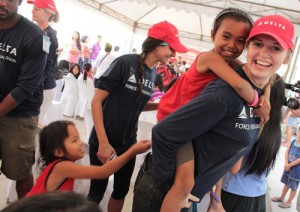 Children play with Galina Rodchuck, a volunteer for the Habitat for Humanity. A thanksgiving party was held yesterday after the volunteers, composed of employees of DAL Airlines, turned over 10 houses built in Payatas, Quezon City.  Photo By Ruy L. Martinez 